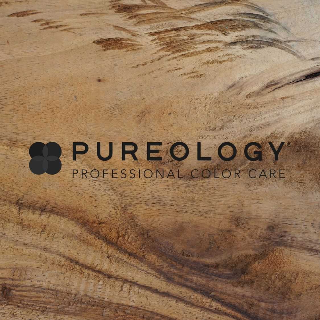 Logo of Pureology Professional Color Care on a wooden background.