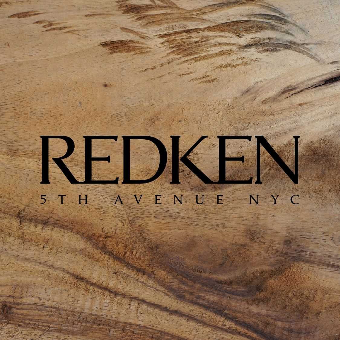 Logo of REDKEN 5th Avenue NYC on a wood grain background.