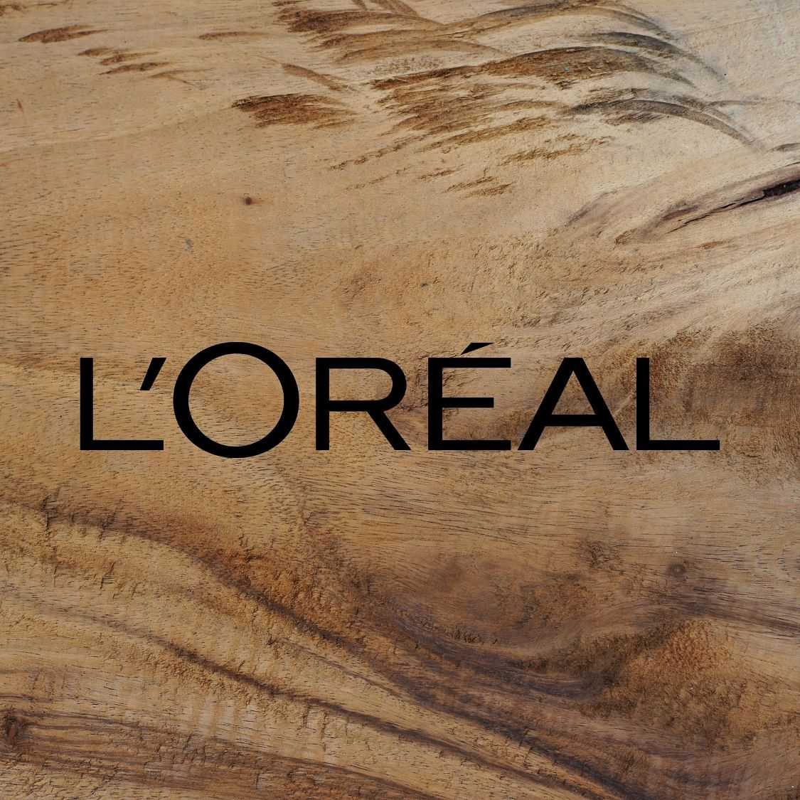 L'Oréal logo displayed over a textured wooden background.